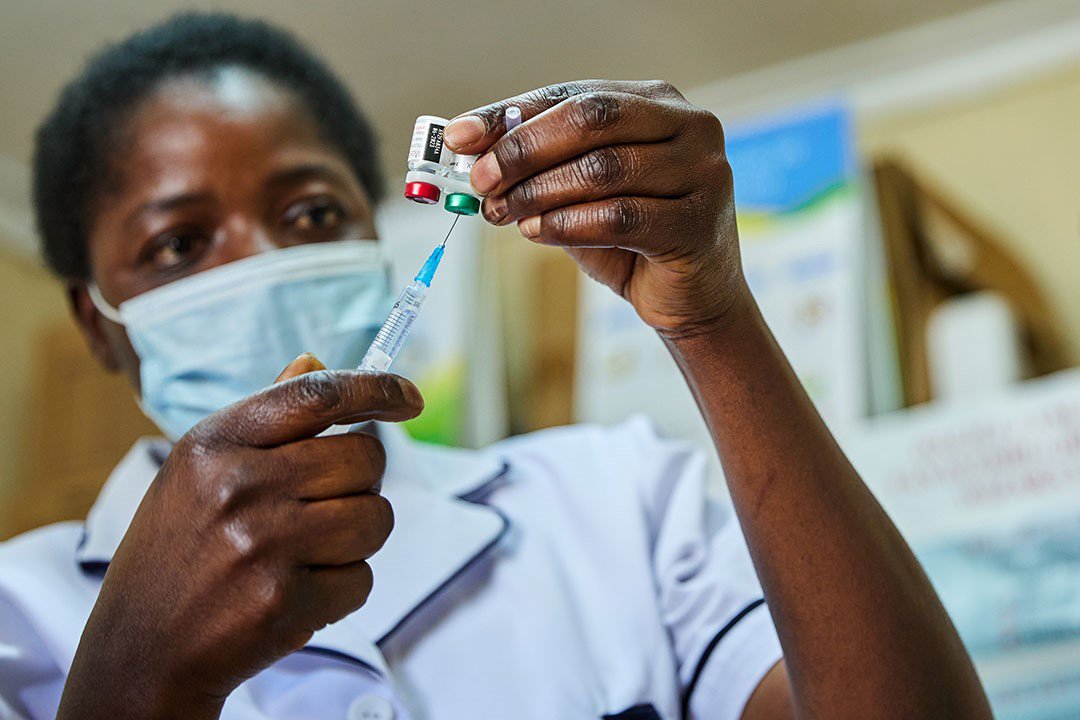 Nurse Janet Wanyama prepares to vaccinate a child with the RTS,S/AS01 malaria vaccine at Malava County Hospital in Kakamega, Kenya. Photo: Gavi/2021/White Rhino Films-Lameck Orina.