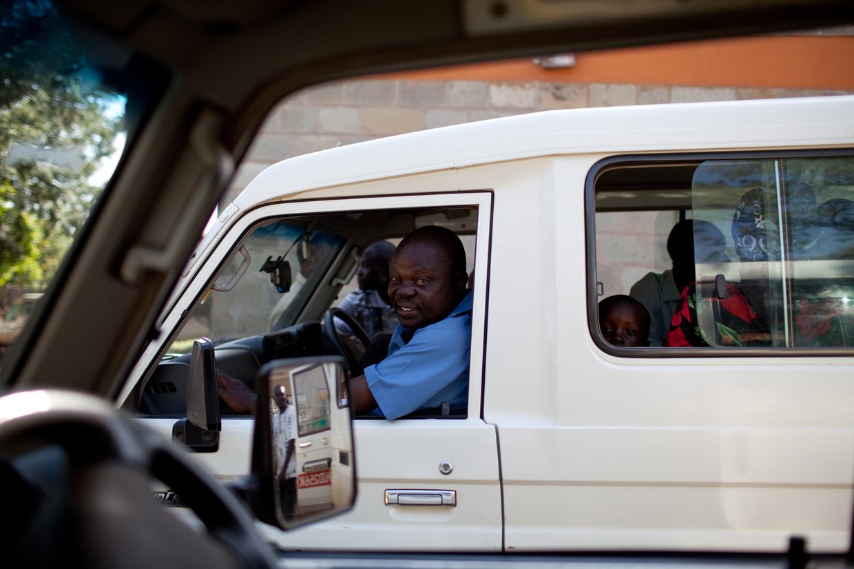 Man sitting in the driver's seat of a white van.