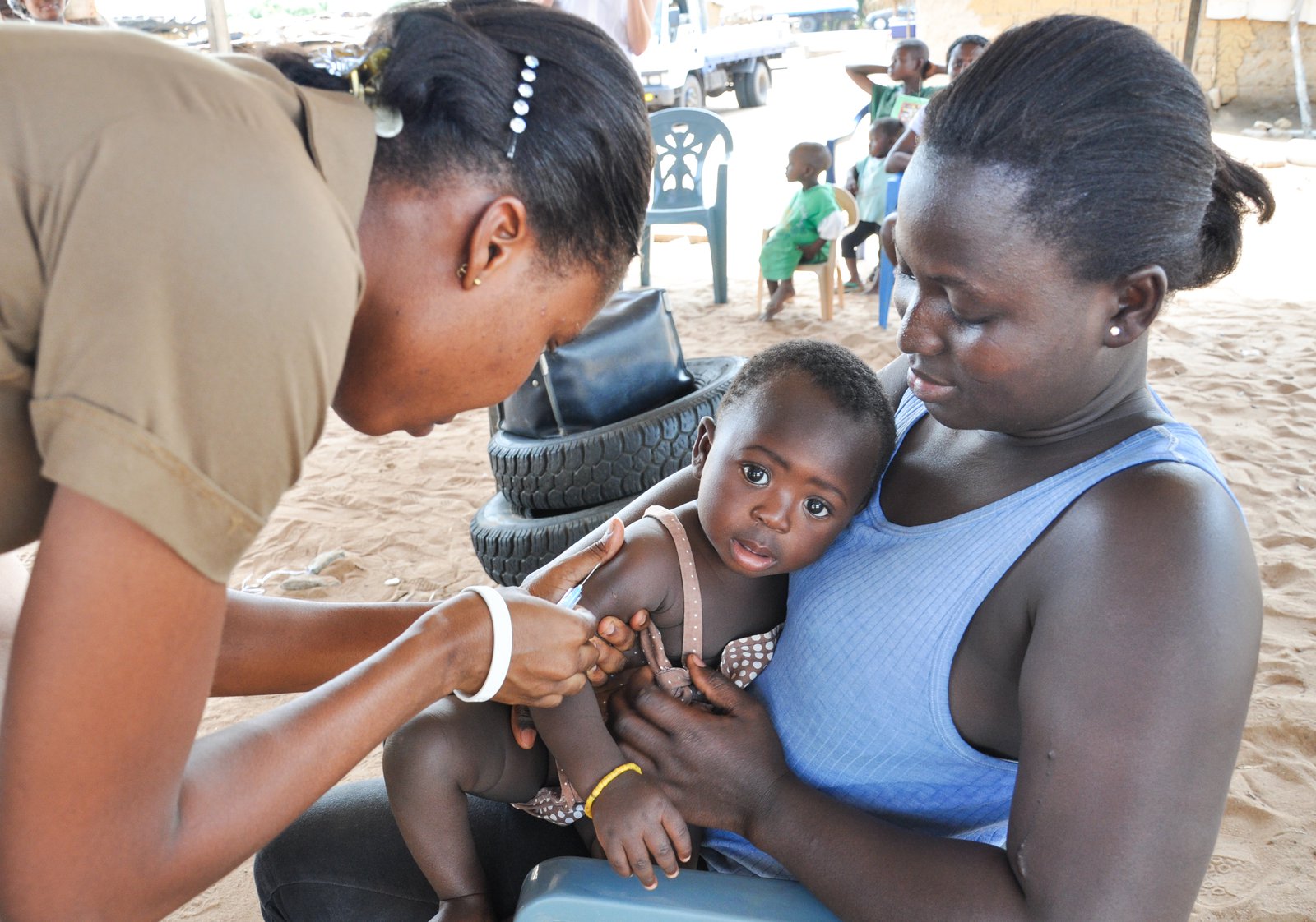 Health worker giving an infant a vaccine.
