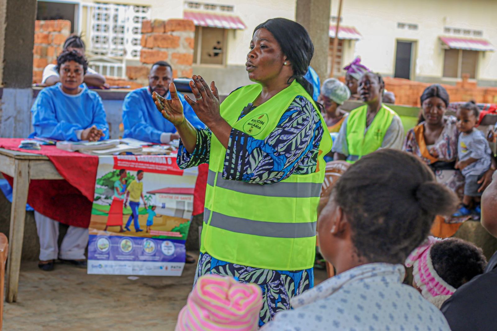 Odile, a community outreach worker, leads an educational talk with women at the Kandu health center in Kisantu health zone, Kongo Central, DRC, prior to a malaria vaccination session. Credit: PATH/Gloddy Tabende.