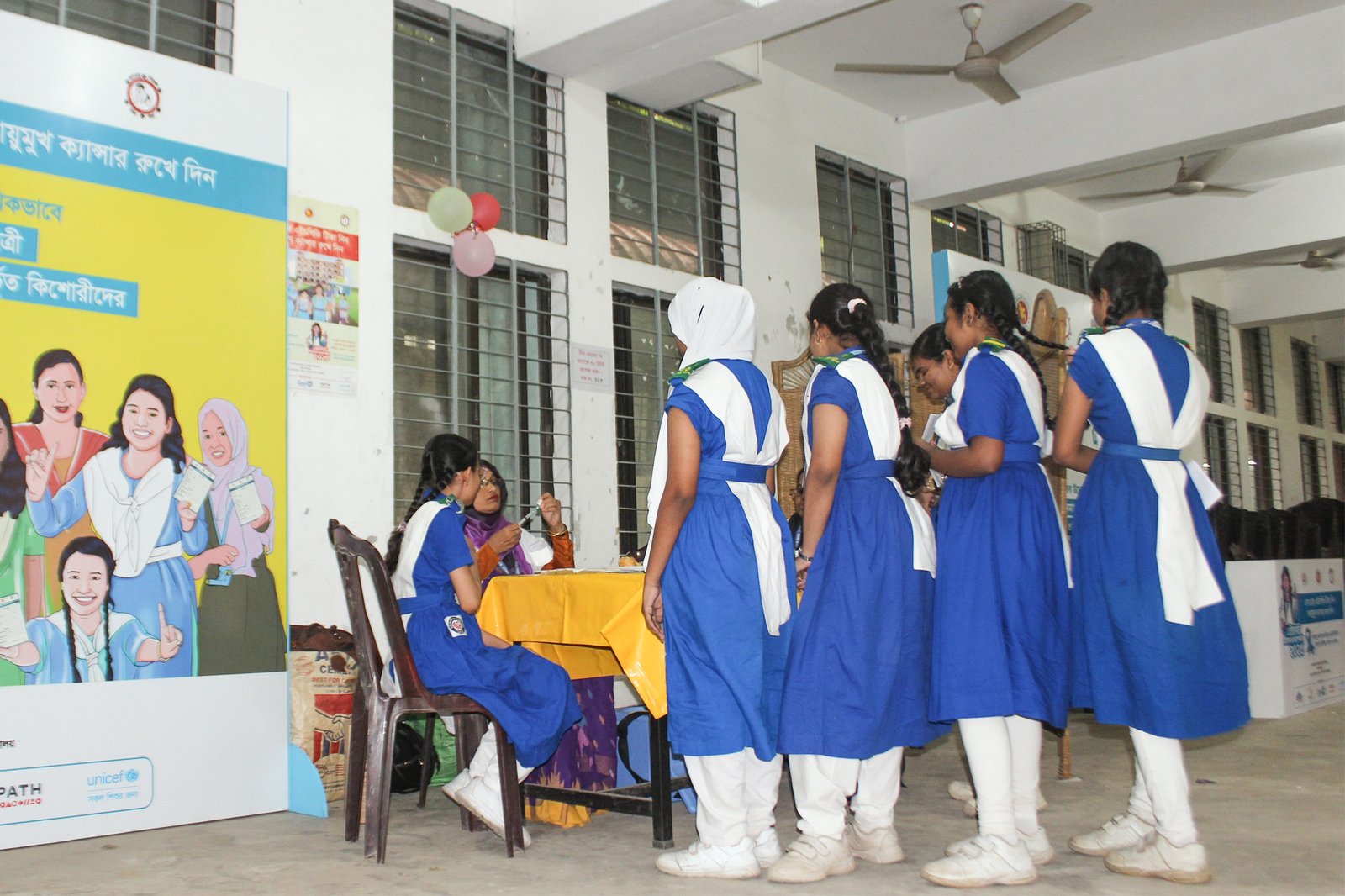 School girls in Bangladesh line up to be vaccinated against HPV during a PATH-supported vaccine introduction campaign.