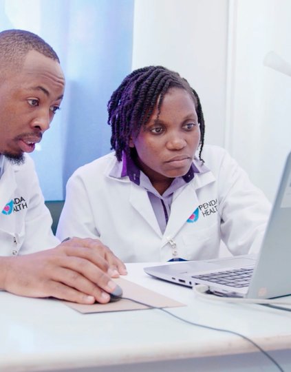 Photo: Oscar Macharia (left) and Naomi Nduitha (right), clinical staff at Penda Medical Centre in Nairobi, use AI to help diagnose patients and determine treatment plans.
