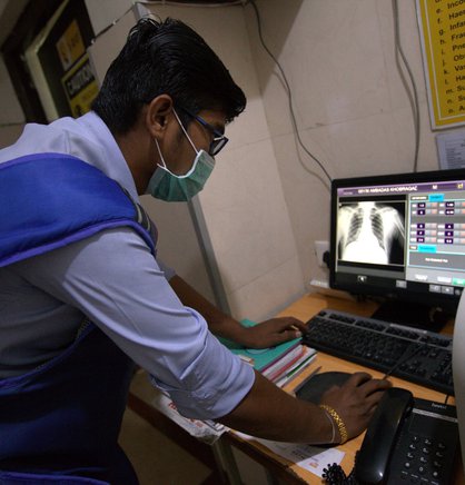 A technician at a chest x-ray laboratory in Nagpur, India, updates patient details in a computer-aided detection software program before running a cloud-based artificial intelligence screening for tuberculosis. Photo: Stop TB Partnership.