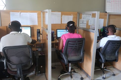 Agents at CDFU’s call center, which provides information, counseling and referrals on a variety of health topics in Uganda, respond to queries and conduct outbound calls. Photo: Joseph Waninda/PATH.