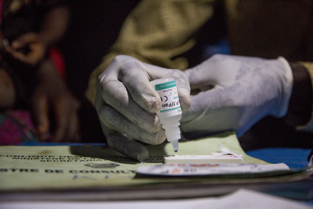 CHW conducts a malaria test in the DRC, PATH photo