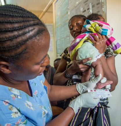 A nurse in Lubumbashi in southeastern DRC gently collects a dried blood spot sample from a newborn, illustrating the routine yet transformative intersection of integrated disease management and primary health care. Photo: PATH/Georgina Goodwin.