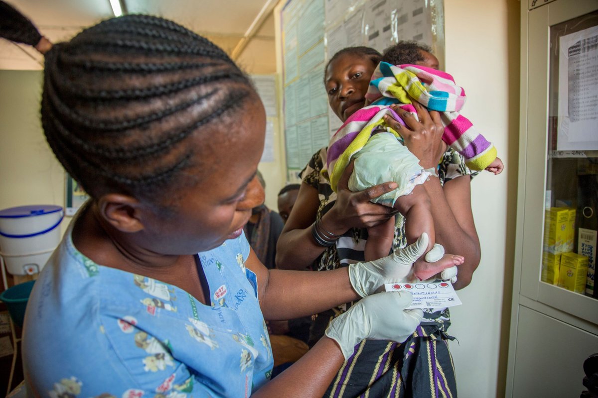 A nurse in Lubumbashi in southeastern DRC gently collects a dried blood spot sample from a newborn, illustrating the routine yet transformative intersection of integrated disease management and primary health care.