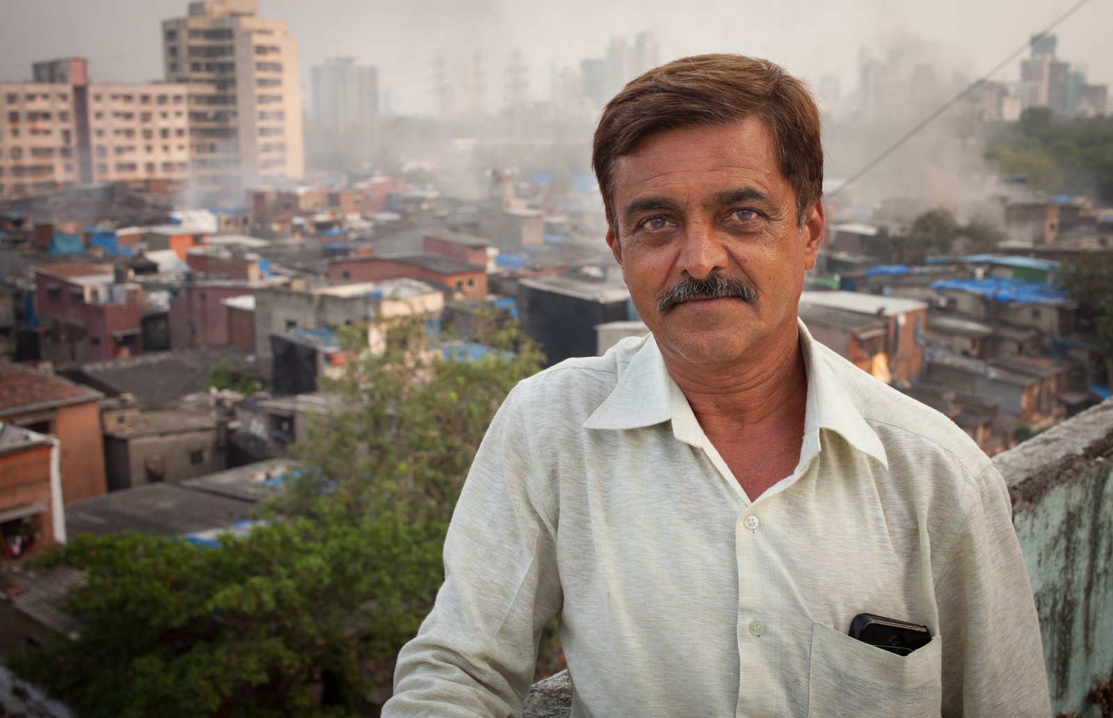 Ajit Bhatt overlooking the crowded buildings of Dharavi slum. Photo: PATH/Tom Furtwangler.