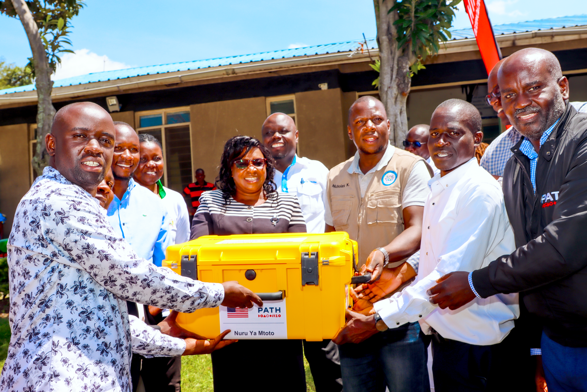PATH Kenya’s Nuru Ya Mtoto project team hands over an AI-enabled portable digital x-ray machine to the Hamisi Sub-County Hospital team, led by Dr. Nicholas Kitungulu, to accelerate rapid TB screening in hard-to-reach areas. Photo: PATH/Denise Akun.