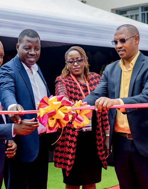 Dr. Francois Uwinkindi (RBC), Amos Mugisha, Margaret Kigwe (AstraZeneca), and Jean Leonard Sekanyange (Vice Mayor of Gatsibo District) cut the ribbon to mark the launch of the expanded HHA project in Rwanda. Photo: PATH/Kanyarwanda Arts.