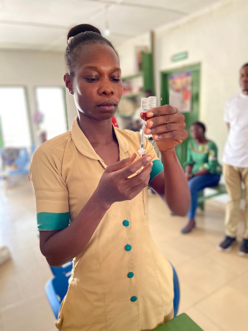 A nurse prepares a dose of the RTS,S malaria vaccine in Ghana