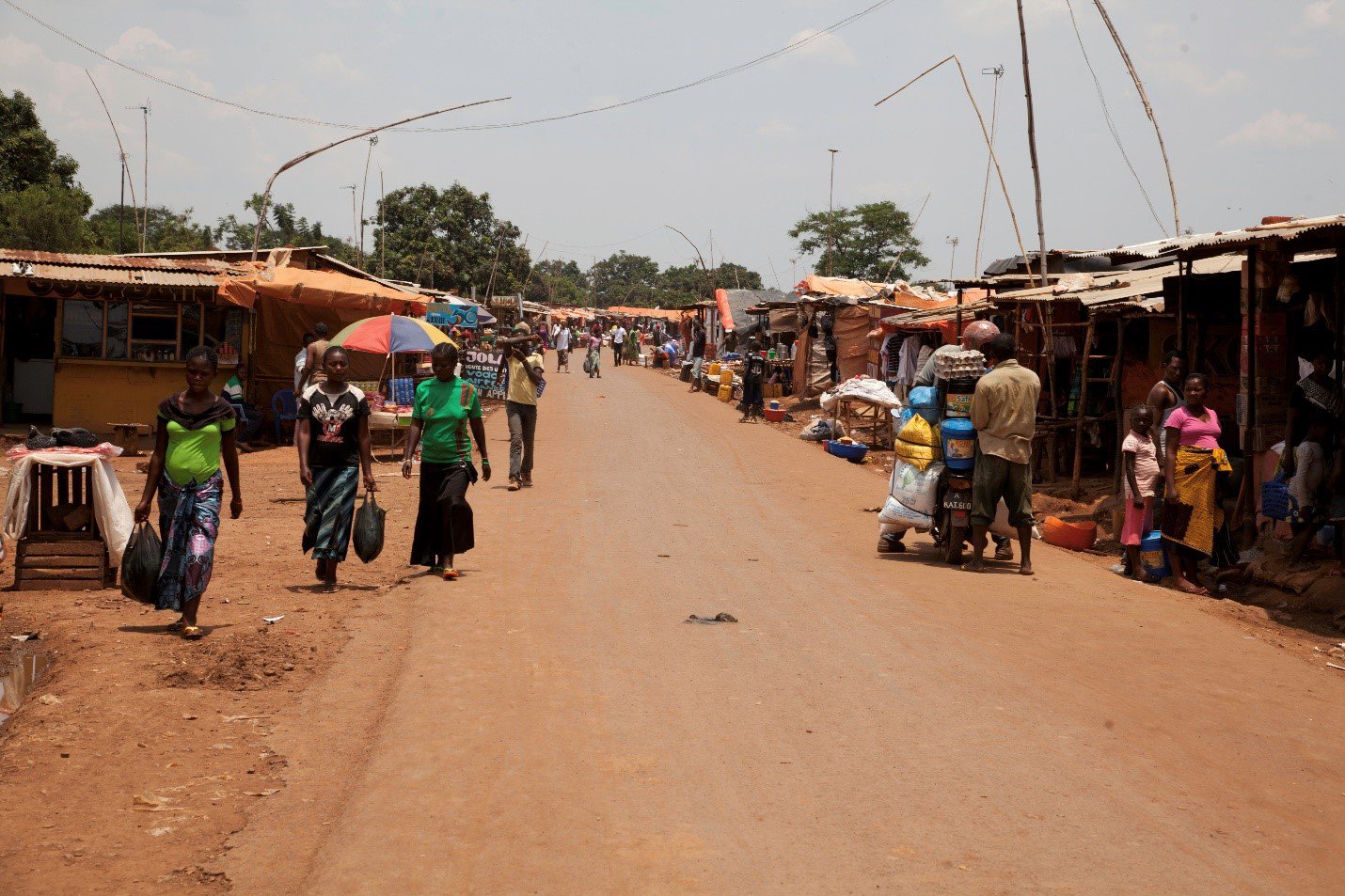 People walking along a dirt road on the outskirts of Kinshasa, the capital of the DRC.