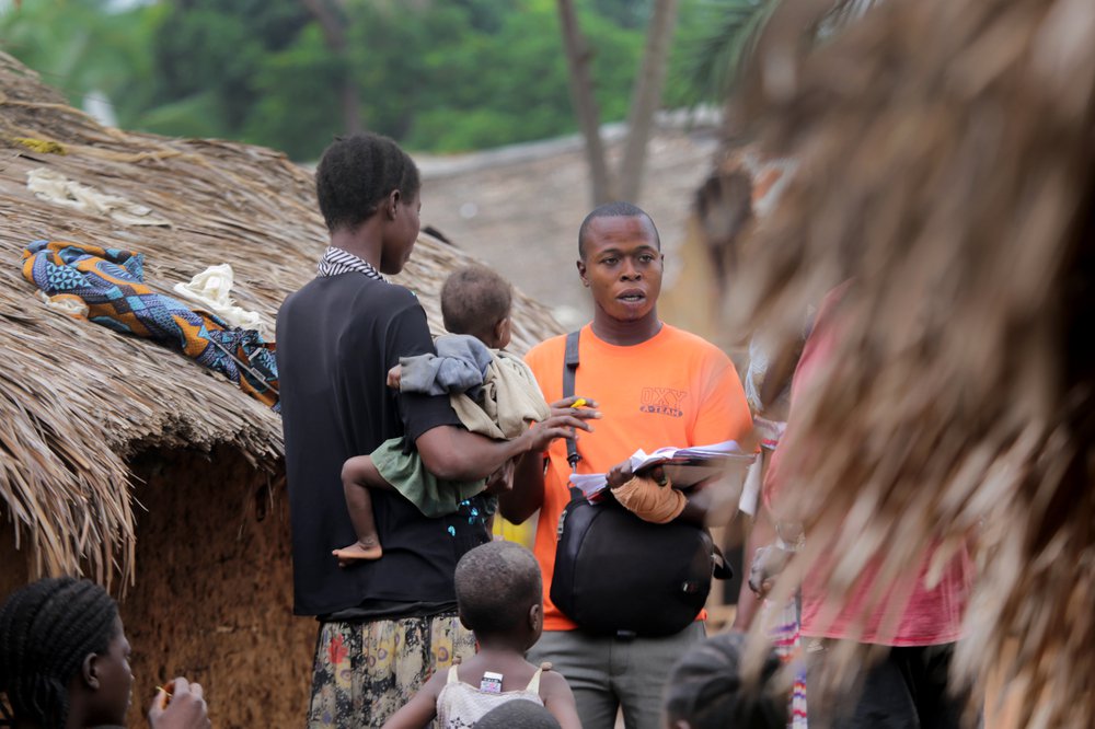 Data system improvements for COVID-19 vaccination may be able to support other vaccination campaigns as well. Here, community outreach worker Mboma Mokanda seeks children unvaccinated against yellow fever in the DRC. Photo: PATH/Carlo Lechea.