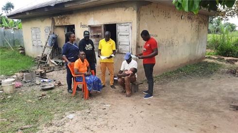 Ward Focal Person and other community health workers following up on and inspecting child health cards to identify eligible and missed dose children for vaccination in Bayelsa State, Nigeria. November 2025. Photo: PATH/Ekpo Edet.