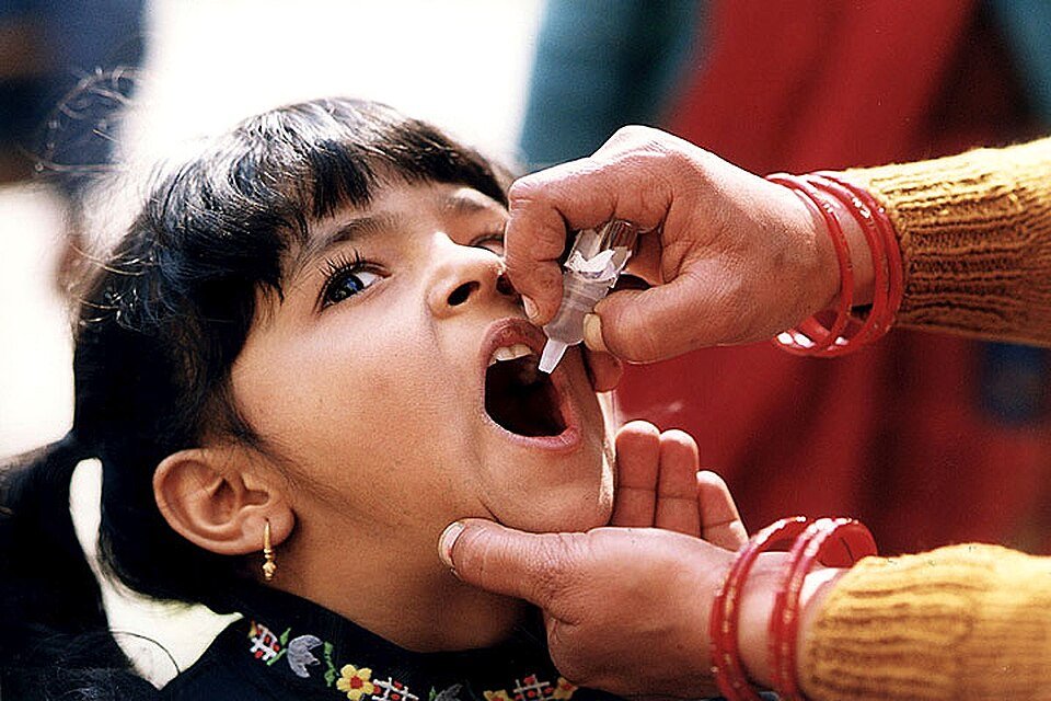 In India, a young girl receives a dose of oral polio vaccine (OPV). Over the last 50 years, OPV has prevented more than 18 million cases of paralysis and brought the world to the brink of eradication. Photo: US Centers for Disease Control and Prevention.