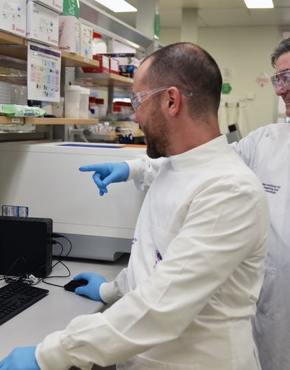 Dr Christian Fercher and Professor David Owen review quality control data for a malaria antigen, part of PEF’s commitment to production of reliable, high-quality proteins supporting global malaria diagnostics. Source: AIBN UQ