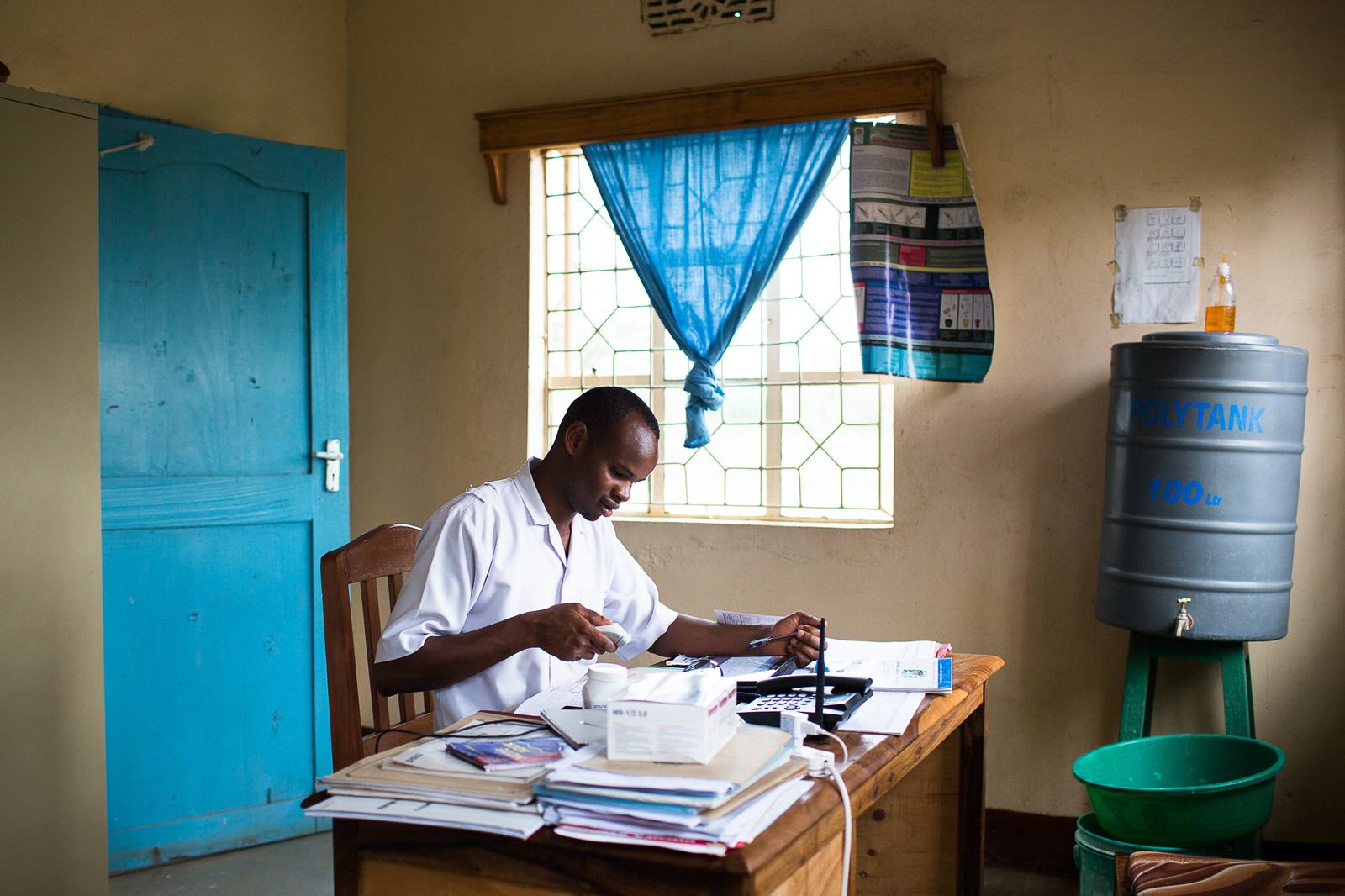 Paulo Urioh, a nurse at Mareu Health Center in Tanzania, using his facility’s electronic immunization registry. Photo: PATH.