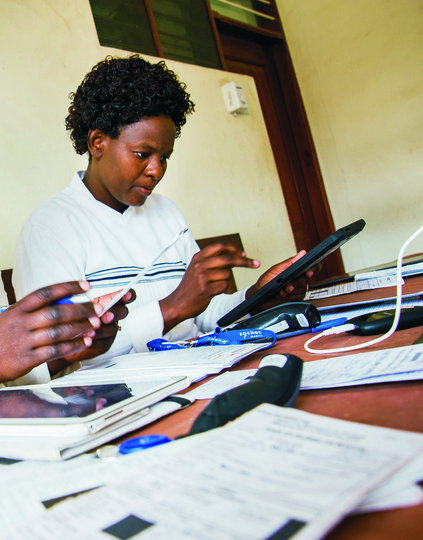 RG451934-edit-2000px.jpg Tanzania healthcare workers working on mobile digital devices. Photo: PATH (BID/digital health via Hallie)