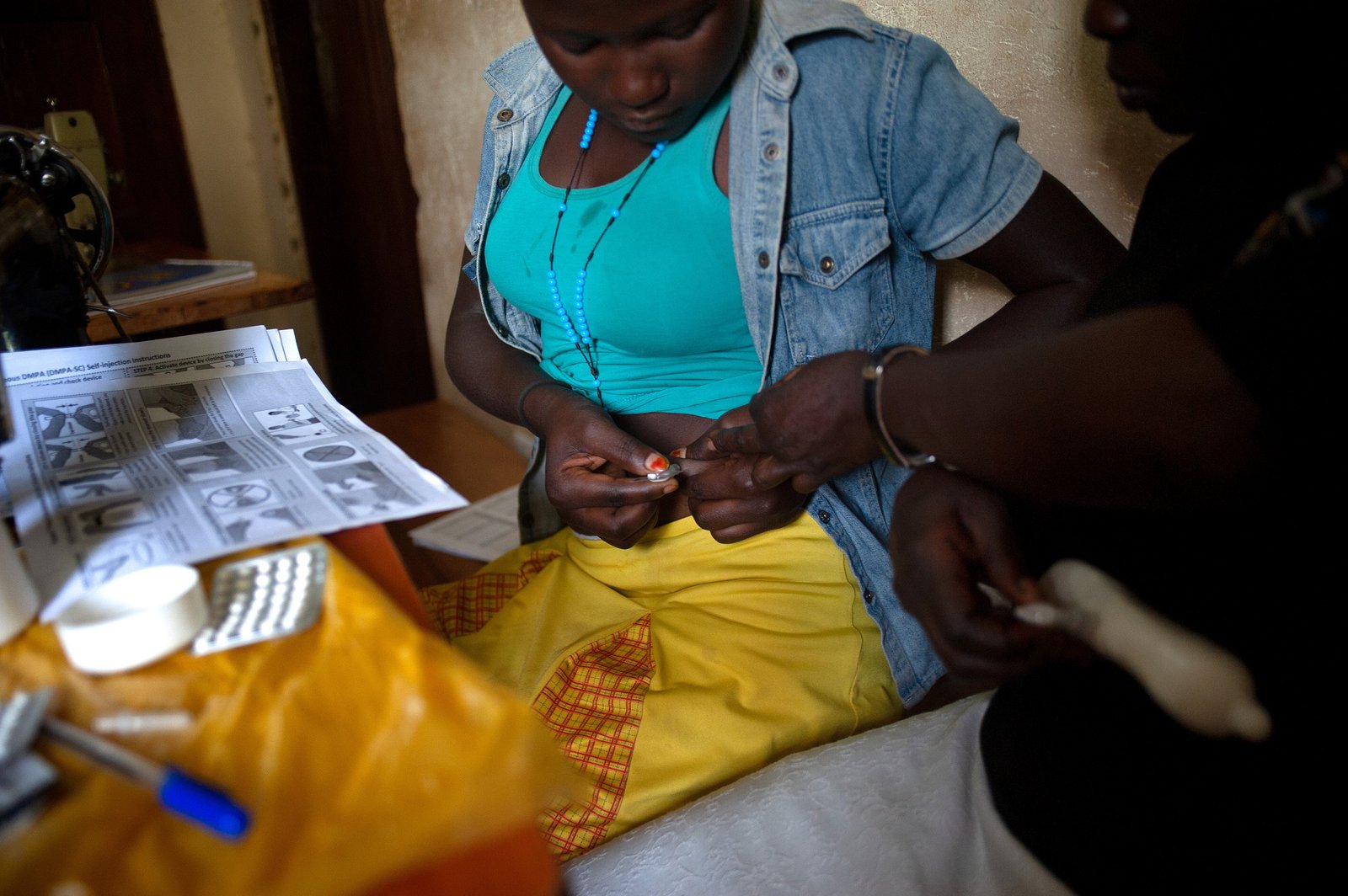 A family planning client in Uganda learns to self-inject the contraceptive DMPA-SC with support from a community health worker. Photo: PATH/Will Boase