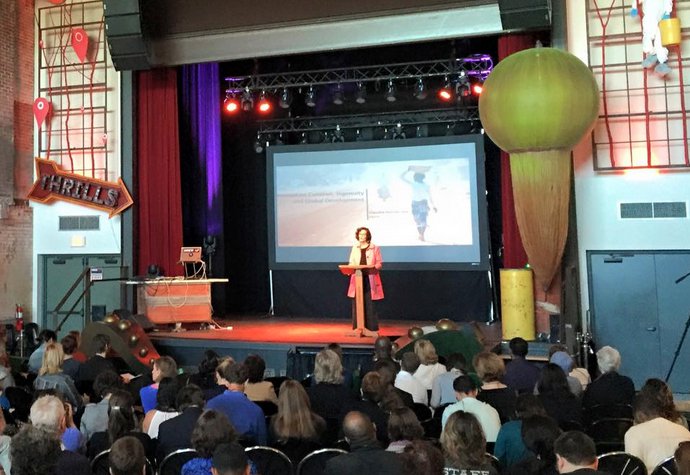 Speaker onstage addressing an audience.