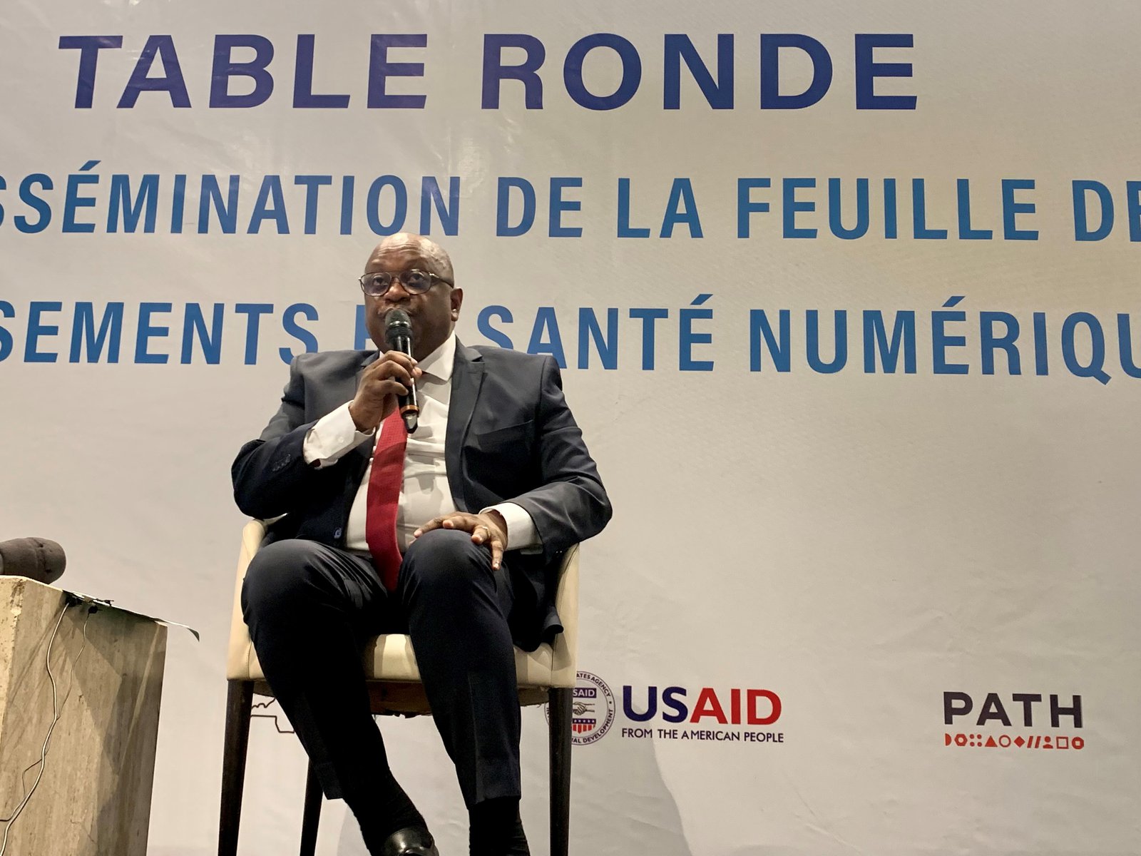 The DRC’s Minister of Health, Hygiene and Prevention, Jean-Jacques Mbungai Mbdanda, speaks at the launch of the National Health Informatics Development Plan investment roadmap in Kinshasa. Photo: PATH/Anne Boher.