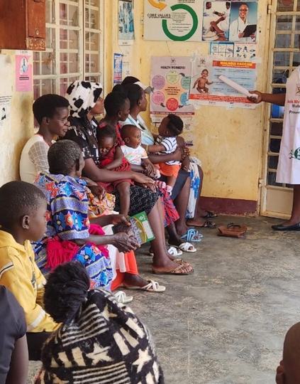 Justine Gimbo, the Assistant Nursing Officer at Buyaga Health Centre II, Masaka District, explaining the malaria vaccine schedule to mothers. Photo: Joseph Waninda/PATH.