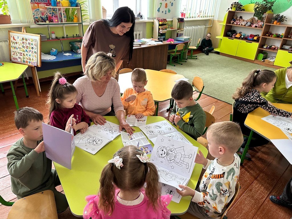 School children in Dubrovytsia, Ukraine, work with their teachers to color images related vaccines and superheroes. PATH worked with local partner 100% Life to develop the materials and messages to reach school-aged children.