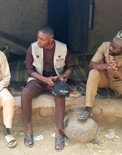 A PATH Program Officer engages with community leaders in Bauchi State, Nigeria, during a rapid assessment exercise following the introduction of the malaria vaccine.