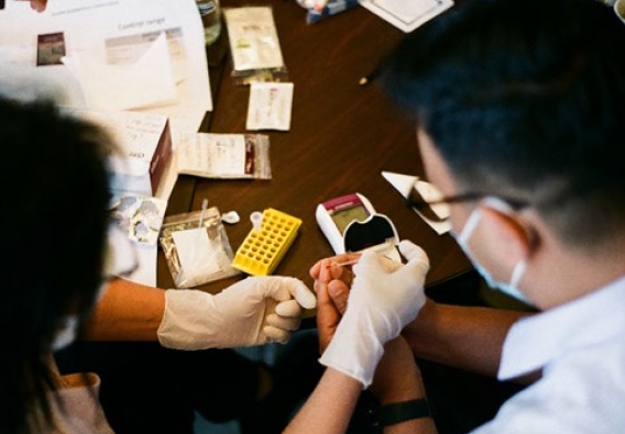 An ADVANCE-trained expert shows a health care provider how to use the G6PD test.