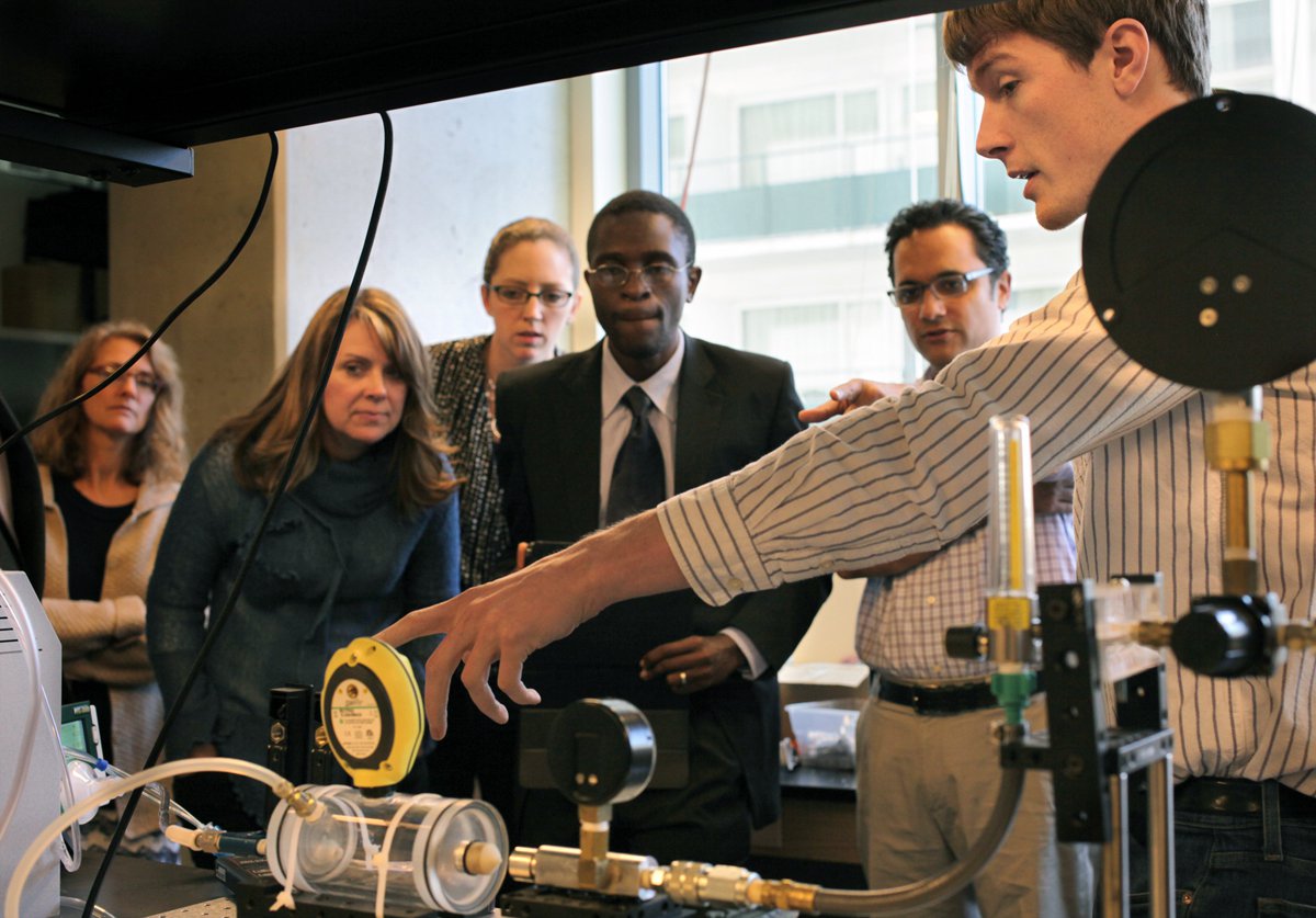 Shop staff member demonstrates equipment for a group.